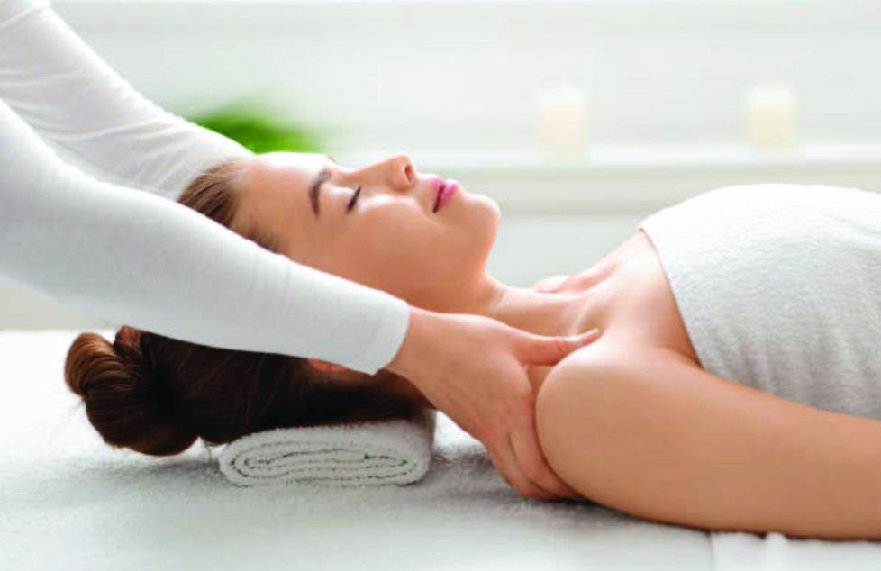 A guest receiving a gentle neck and shoulder massage